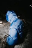 Blue puffer jacket on a dark background
