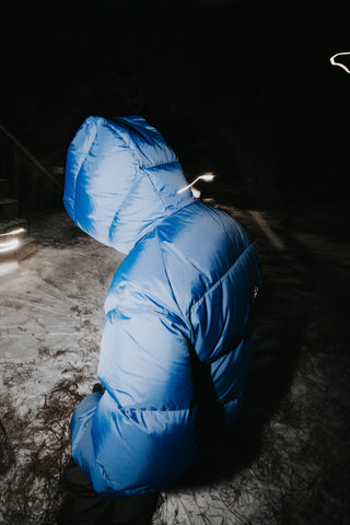 Blue puffer jacket on a dark background