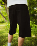 BUSI Biggie Shorts Black denim shorts, back view on model outdoors