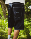 BUSI Biggie Shorts Rinse Blue denim shorts, back view on model outdoors