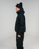 BUSI Core Jacket Black snowboard and ski jacket, side view on model
