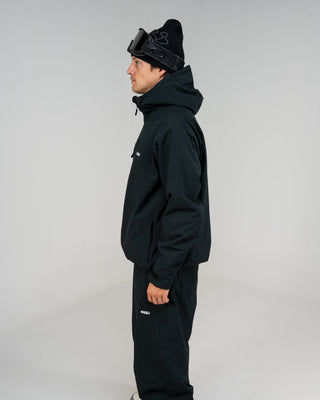 BUSI Core Jacket Black snowboard and ski jacket, side view on model